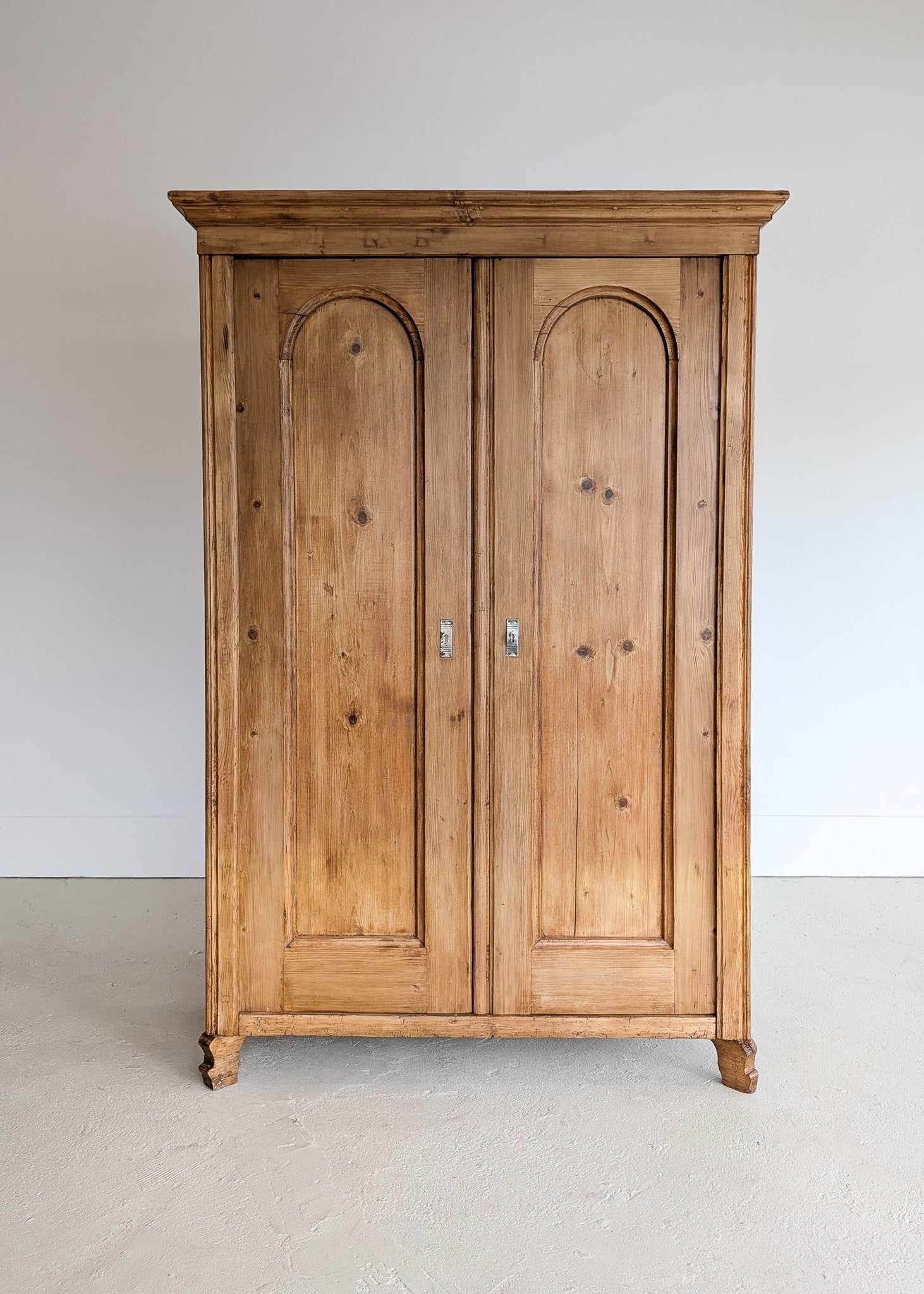 Handsome Antique European Pine Cabinet with Arched Panel Doors, Carved Feet and Skeleton Key