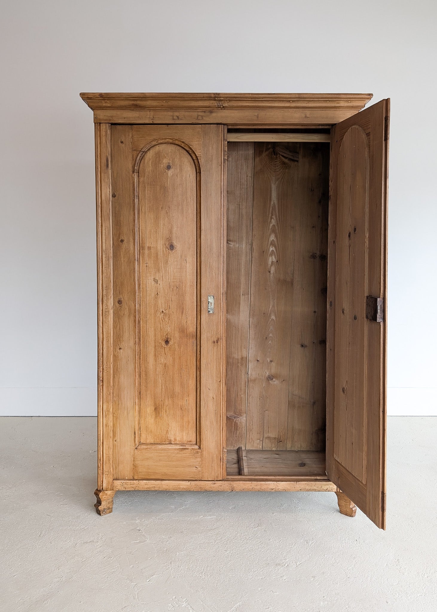 Handsome Antique European Pine Cabinet with Arched Panel Doors, Carved Feet and Skeleton Key