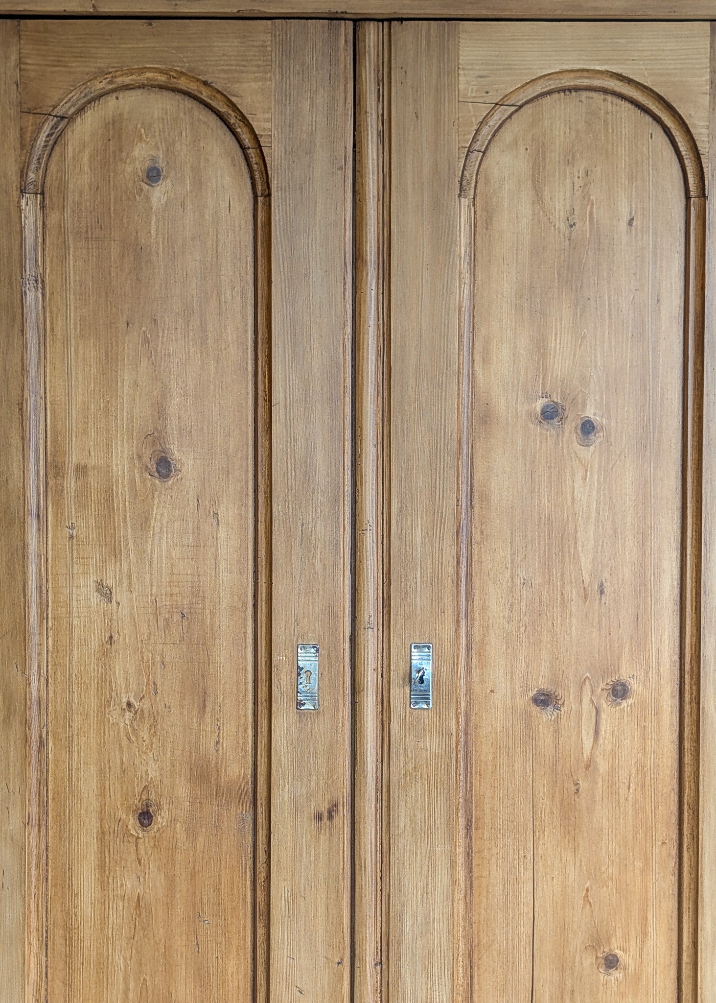 Handsome Antique European Pine Cabinet with Arched Panel Doors, Carved Feet and Skeleton Key