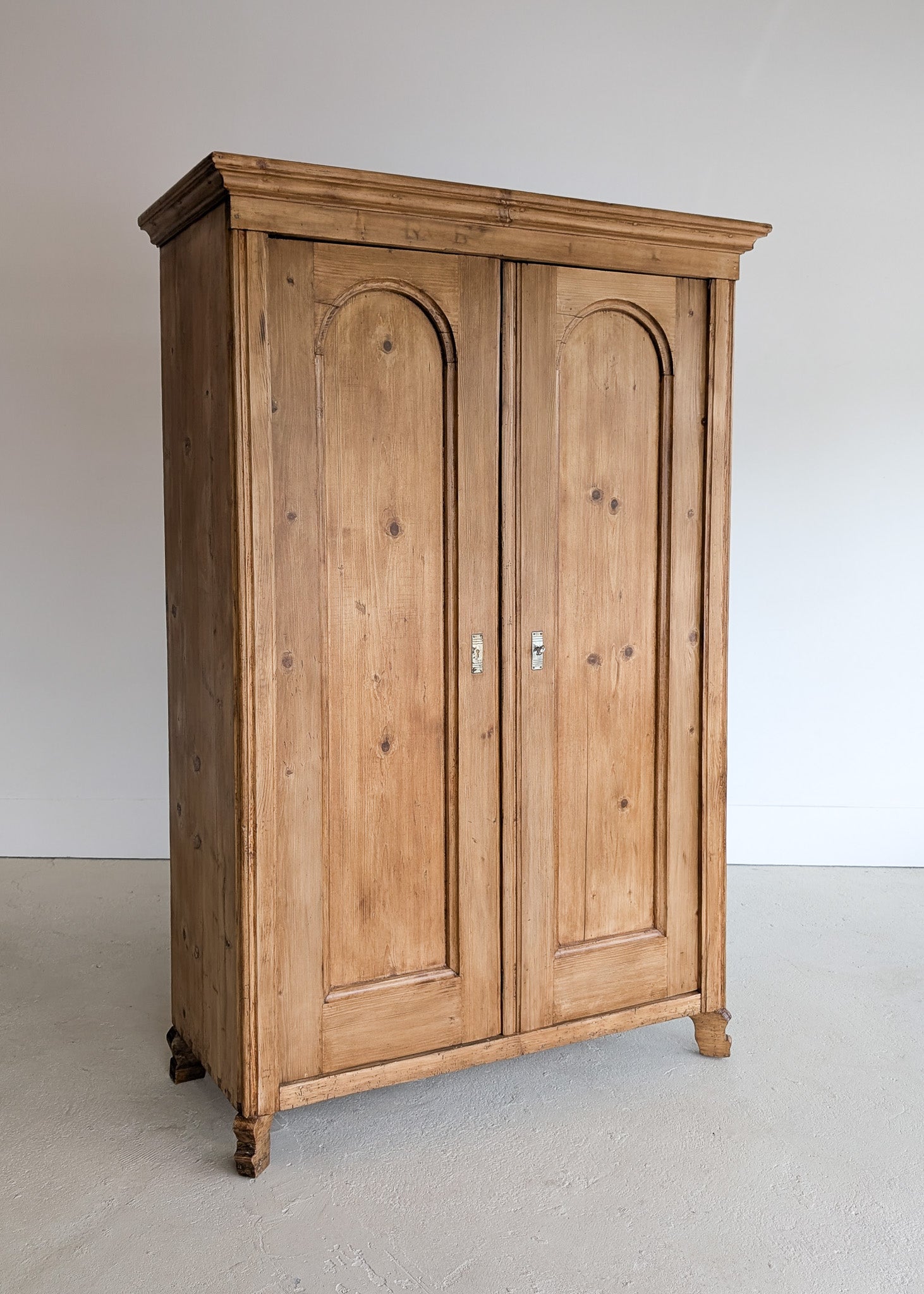 Handsome Antique European Pine Cabinet with Arched Panel Doors, Carved Feet and Skeleton Key