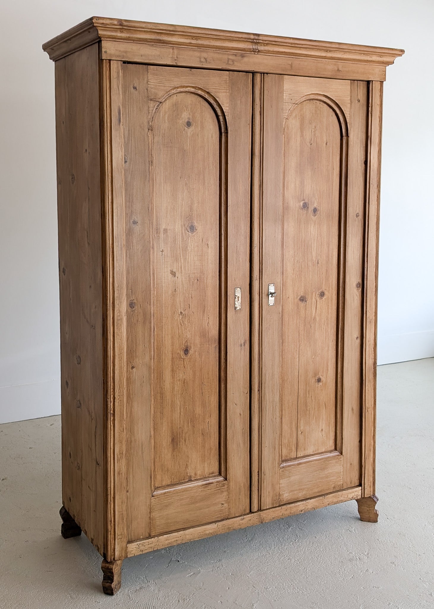 Handsome Antique European Pine Cabinet with Arched Panel Doors, Carved Feet and Skeleton Key