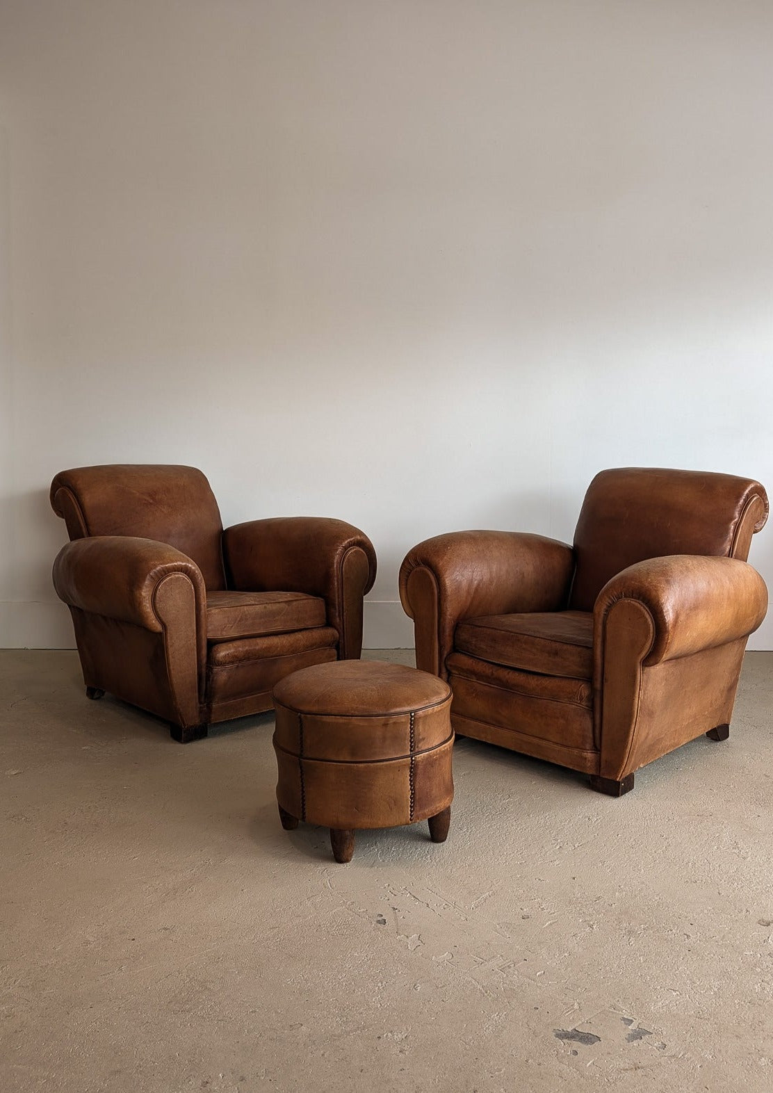 Pair of Vintage 1970s French Leather Club Chairs and Matching Leather Hassock