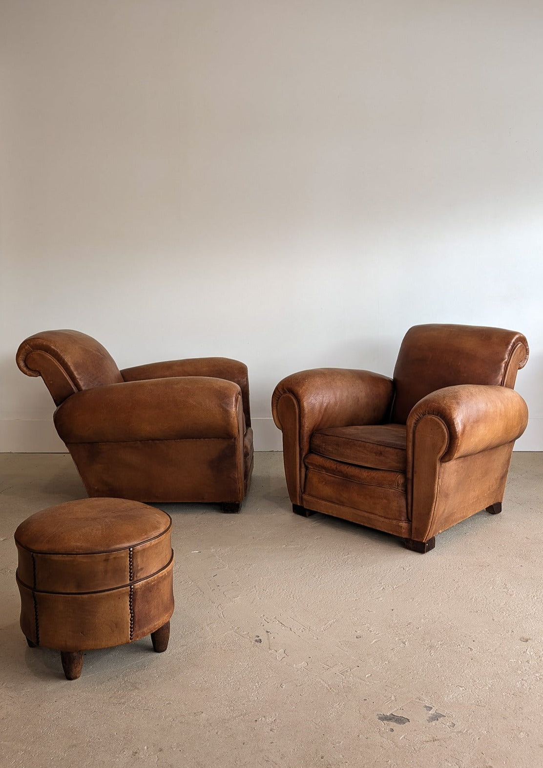 Pair of Vintage 1970s French Leather Club Chairs and Matching Leather Hassock