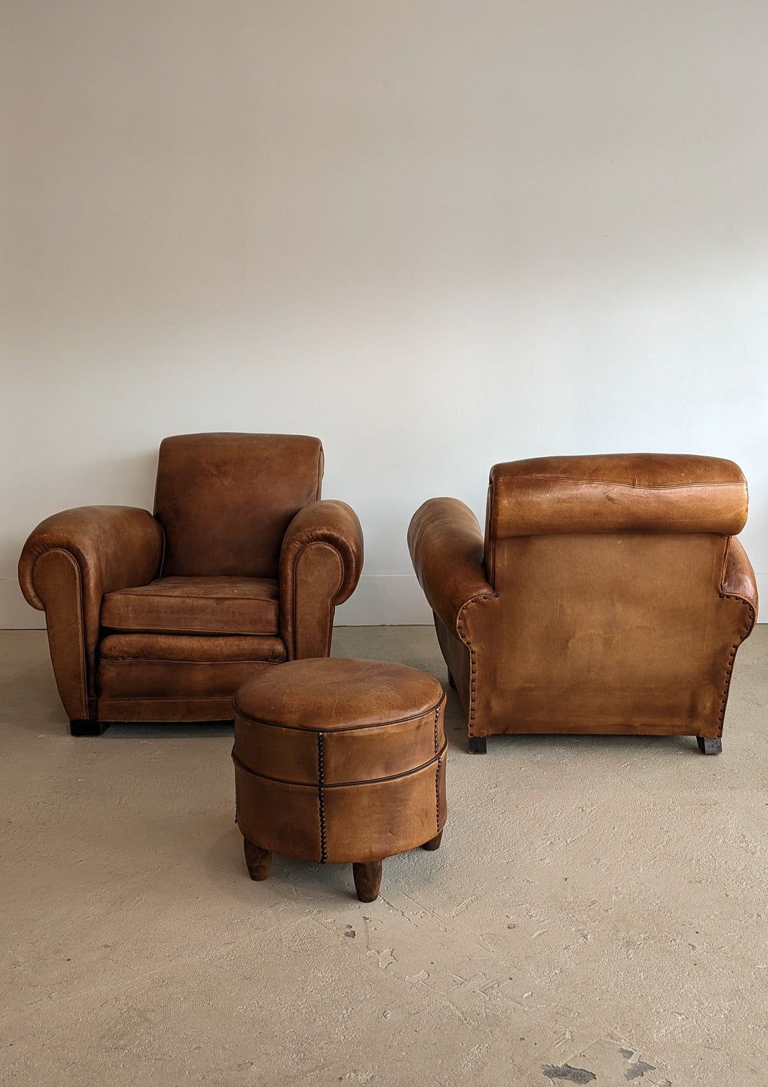 Pair of Vintage 1970s French Leather Club Chairs and Matching Leather Hassock