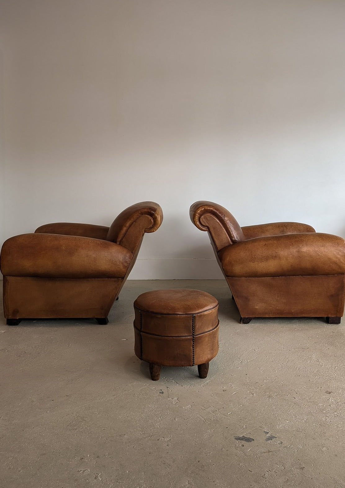 Pair of Vintage 1970s French Leather Club Chairs and Matching Leather Hassock