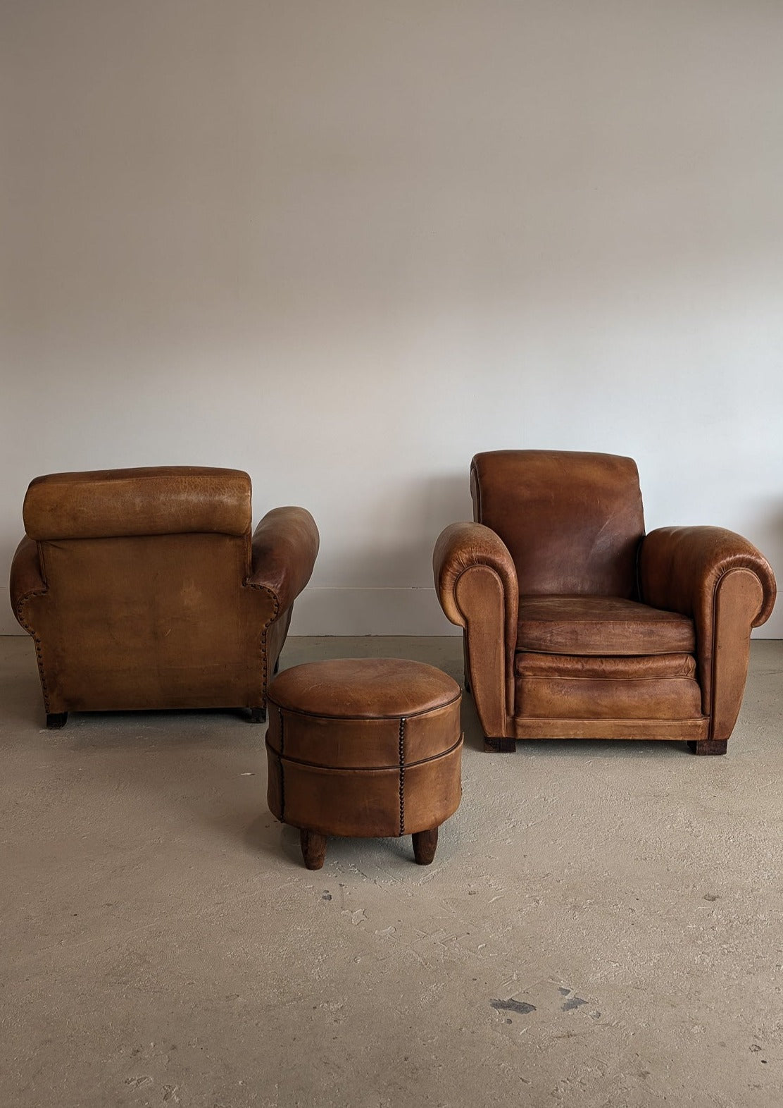 Pair of Vintage 1970s French Leather Club Chairs and Matching Leather Hassock