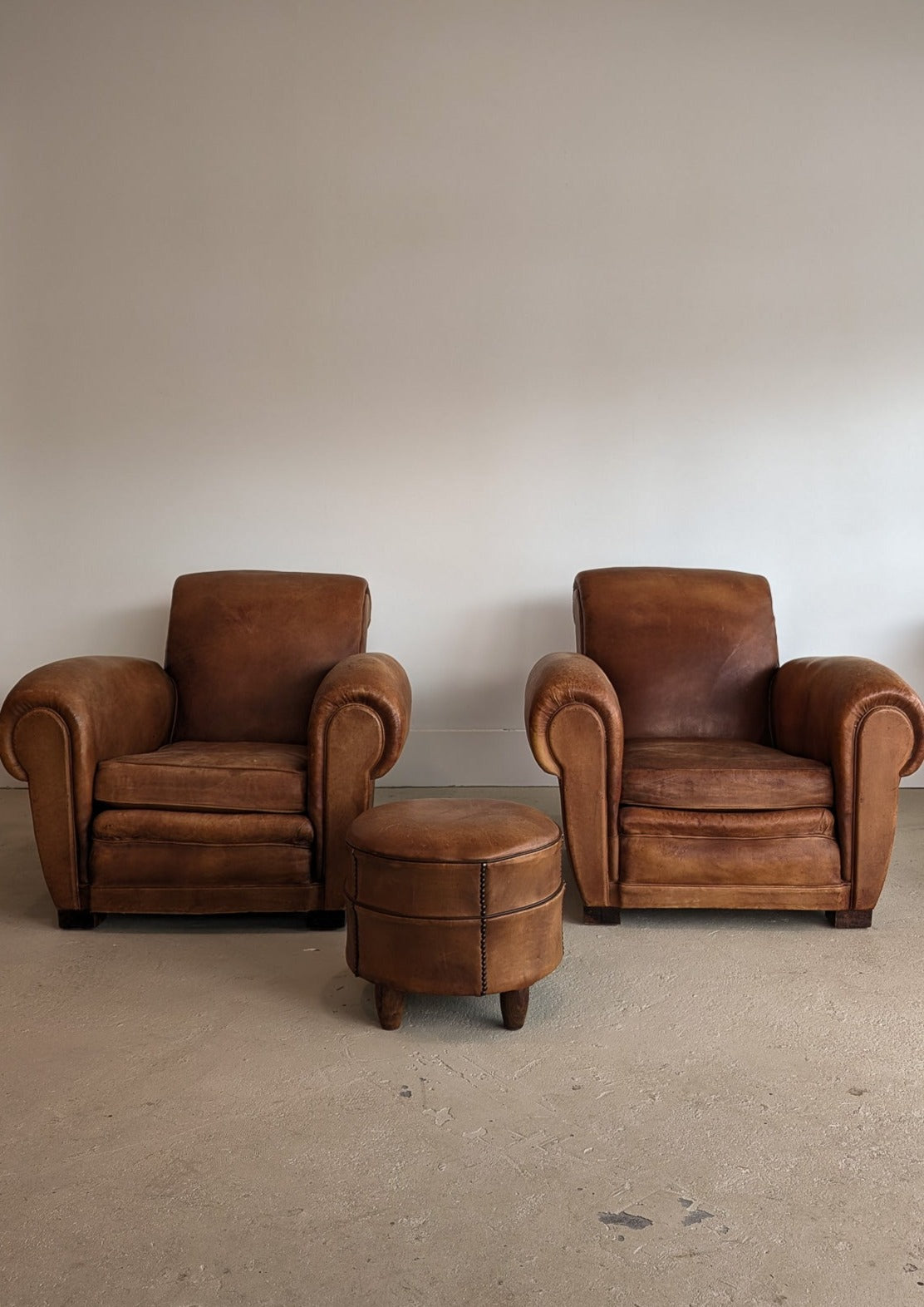 Pair of Vintage 1970s French Leather Club Chairs and Matching Leather Hassock