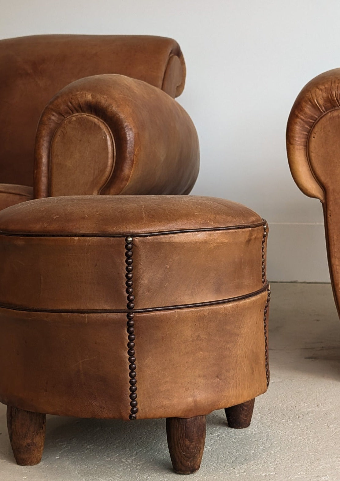 Pair of Vintage 1970s French Leather Club Chairs and Matching Leather Hassock