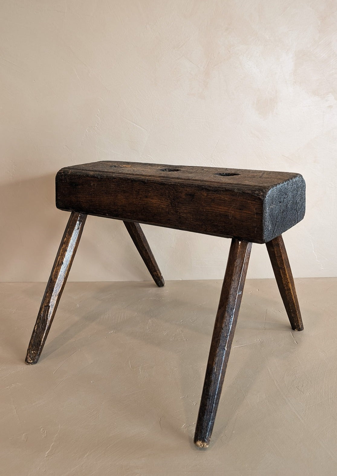 Dark Wooden Primitive Handmade Stool with Holes on Top