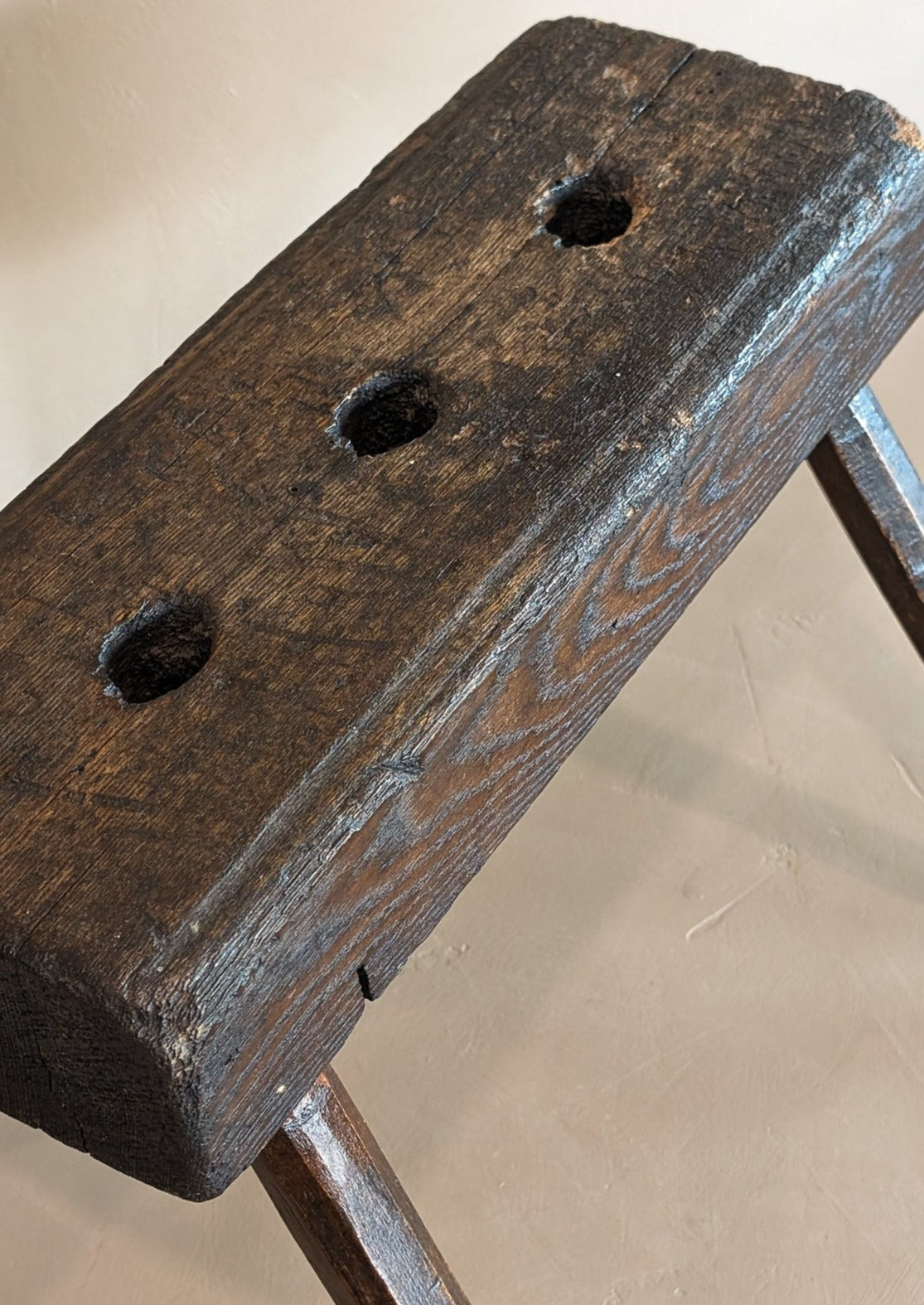 Dark Wooden Primitive Handmade Stool with Holes on Top