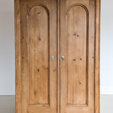 Handsome Antique European Pine Cabinet with Arched Panel Doors, Carved Feet and Skeleton Key