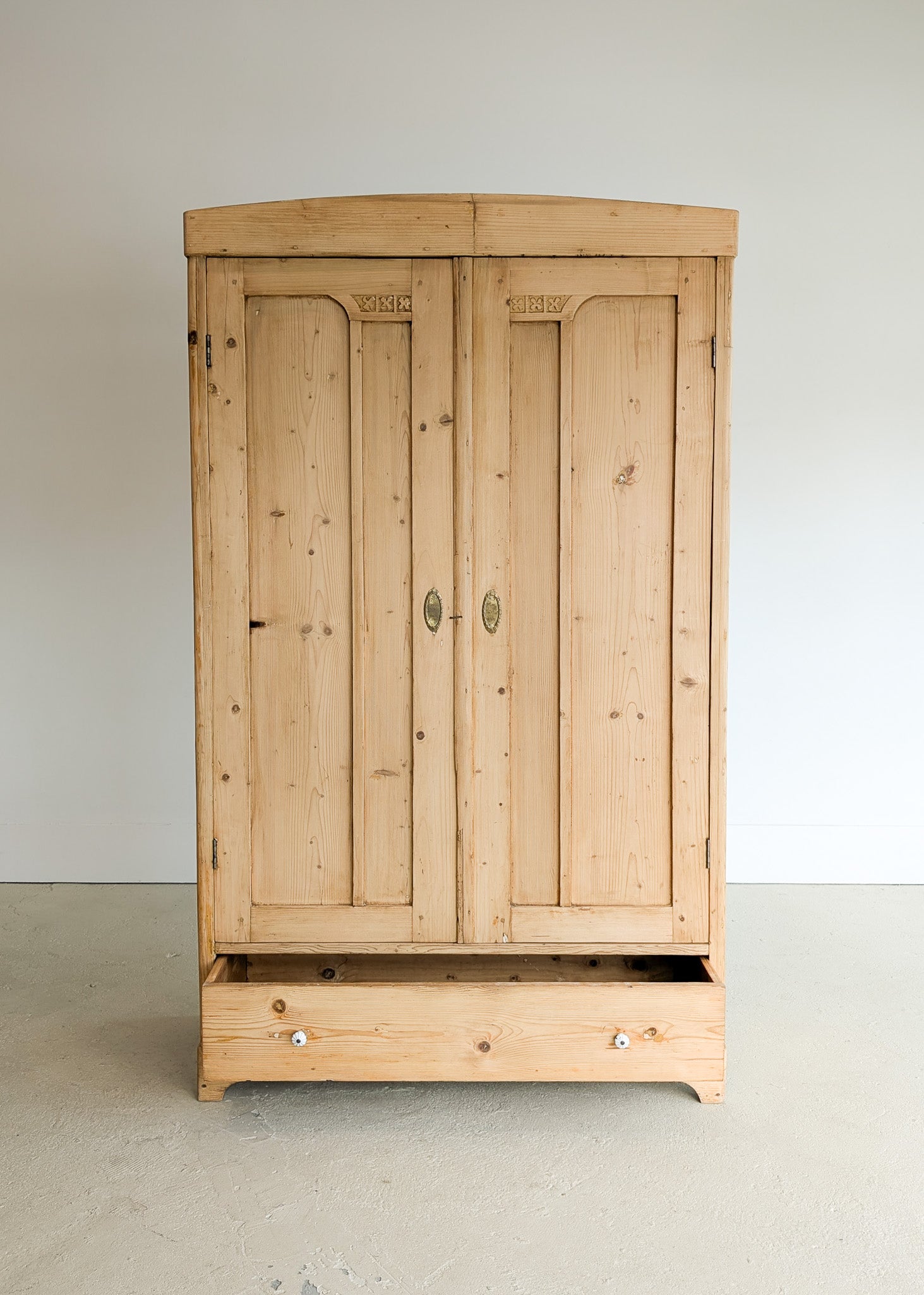Antique European Light Pine Cabinet with Hand-Carved Detailing and Bottom Drawer