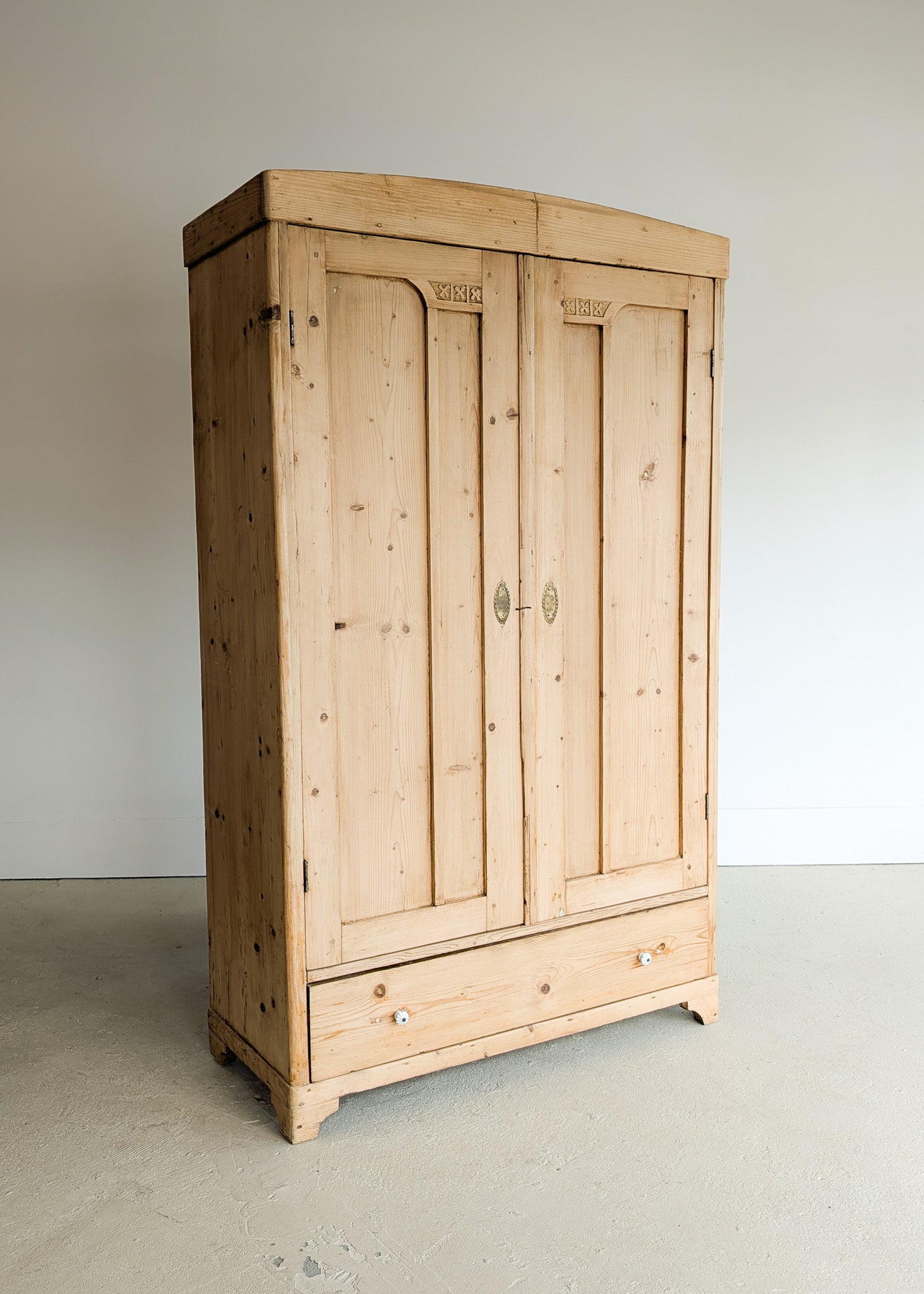 Antique European Light Pine Cabinet with Hand-Carved Detailing and Bottom Drawer