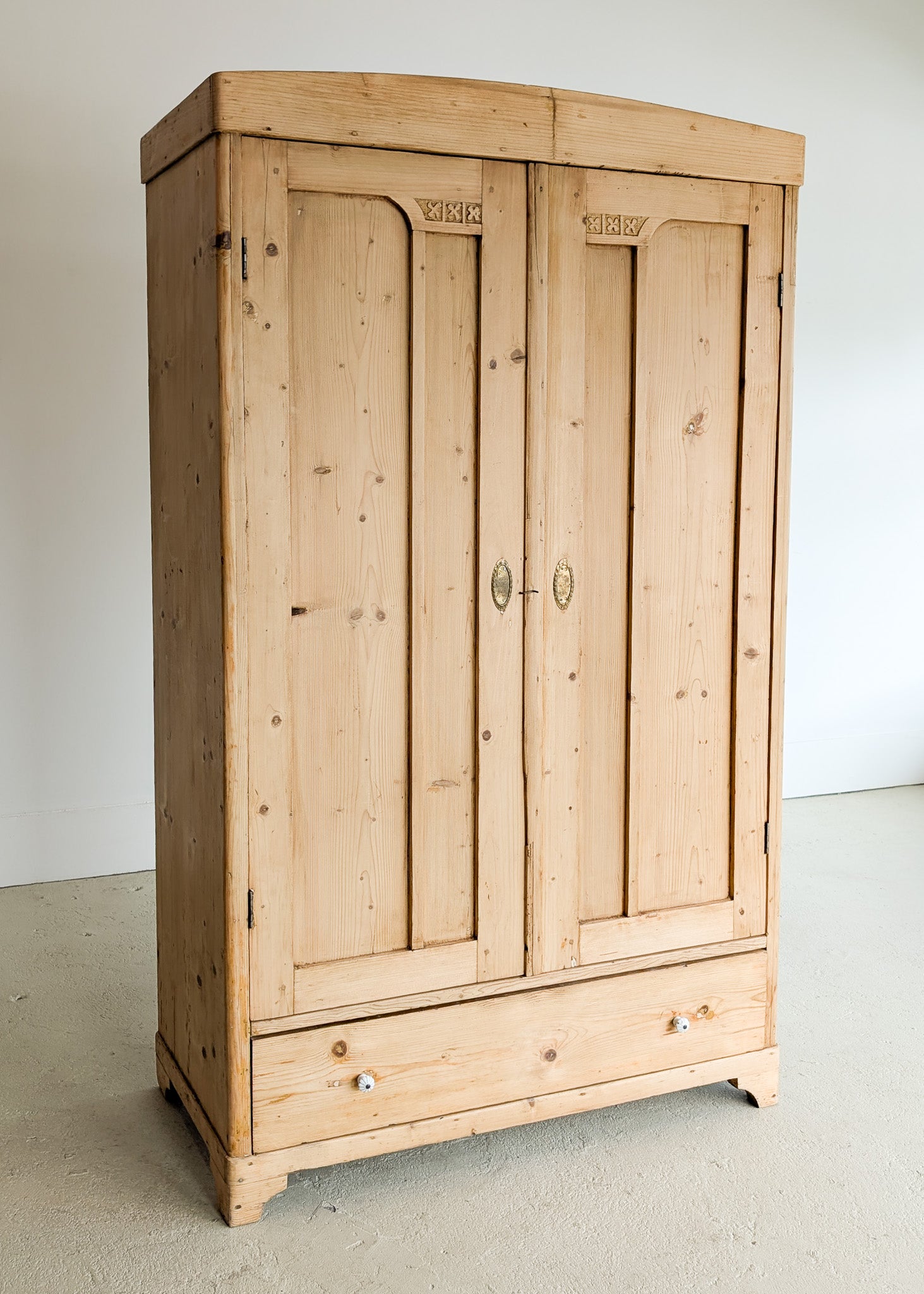 Antique European Light Pine Cabinet with Hand-Carved Detailing and Bottom Drawer