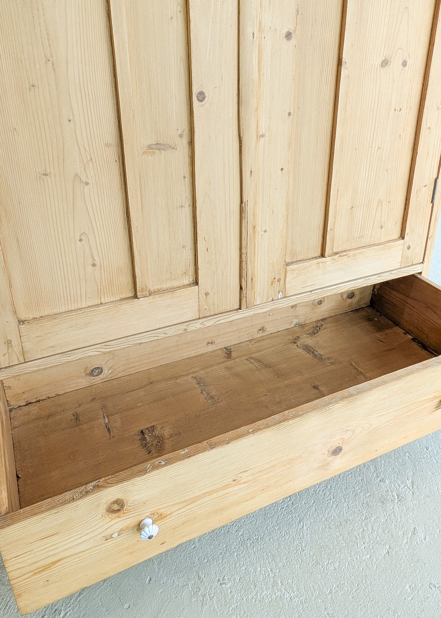 Antique European Light Pine Cabinet with Hand-Carved Detailing and Bottom Drawer