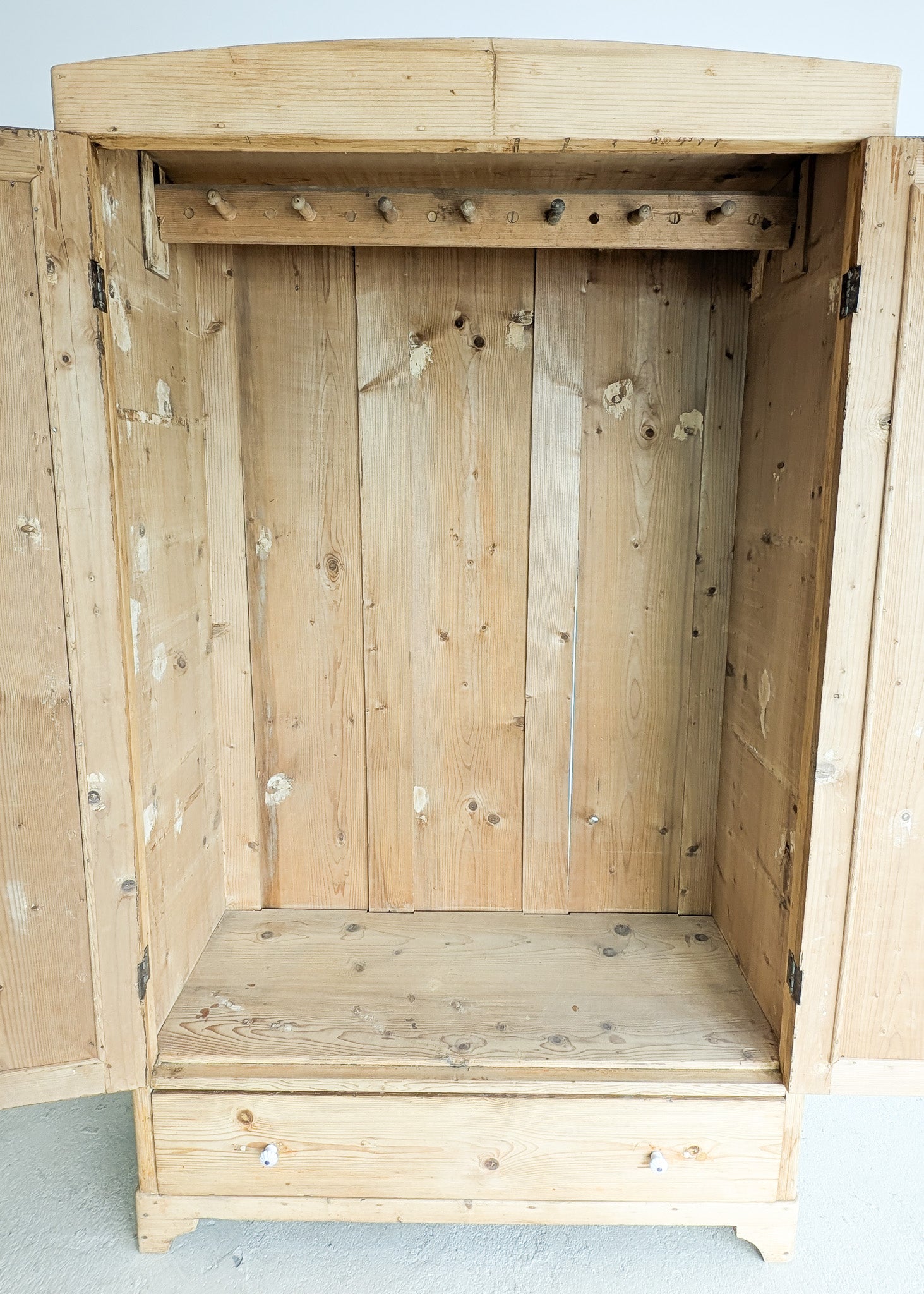 Antique European Light Pine Cabinet with Hand-Carved Detailing and Bottom Drawer