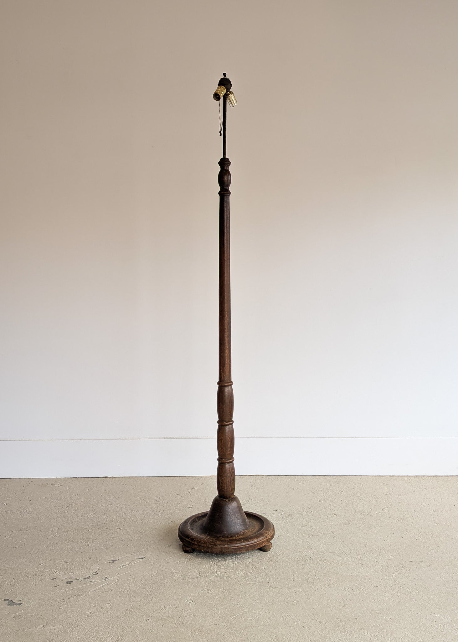 Six-Foot-Tall Antique European Charles Dudouyt-Style Wooden Oak Two-Light Spindle Floor Lamp with Bell-Shaped Base and Ball Feet