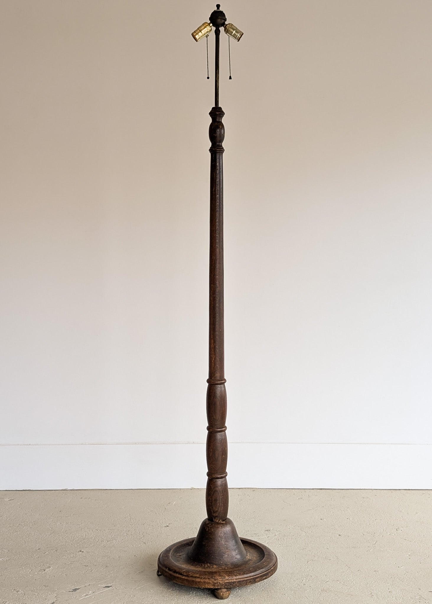 Six-Foot-Tall Antique European Charles Dudouyt-Style Wooden Oak Two-Light Spindle Floor Lamp with Bell-Shaped Base and Ball Feet