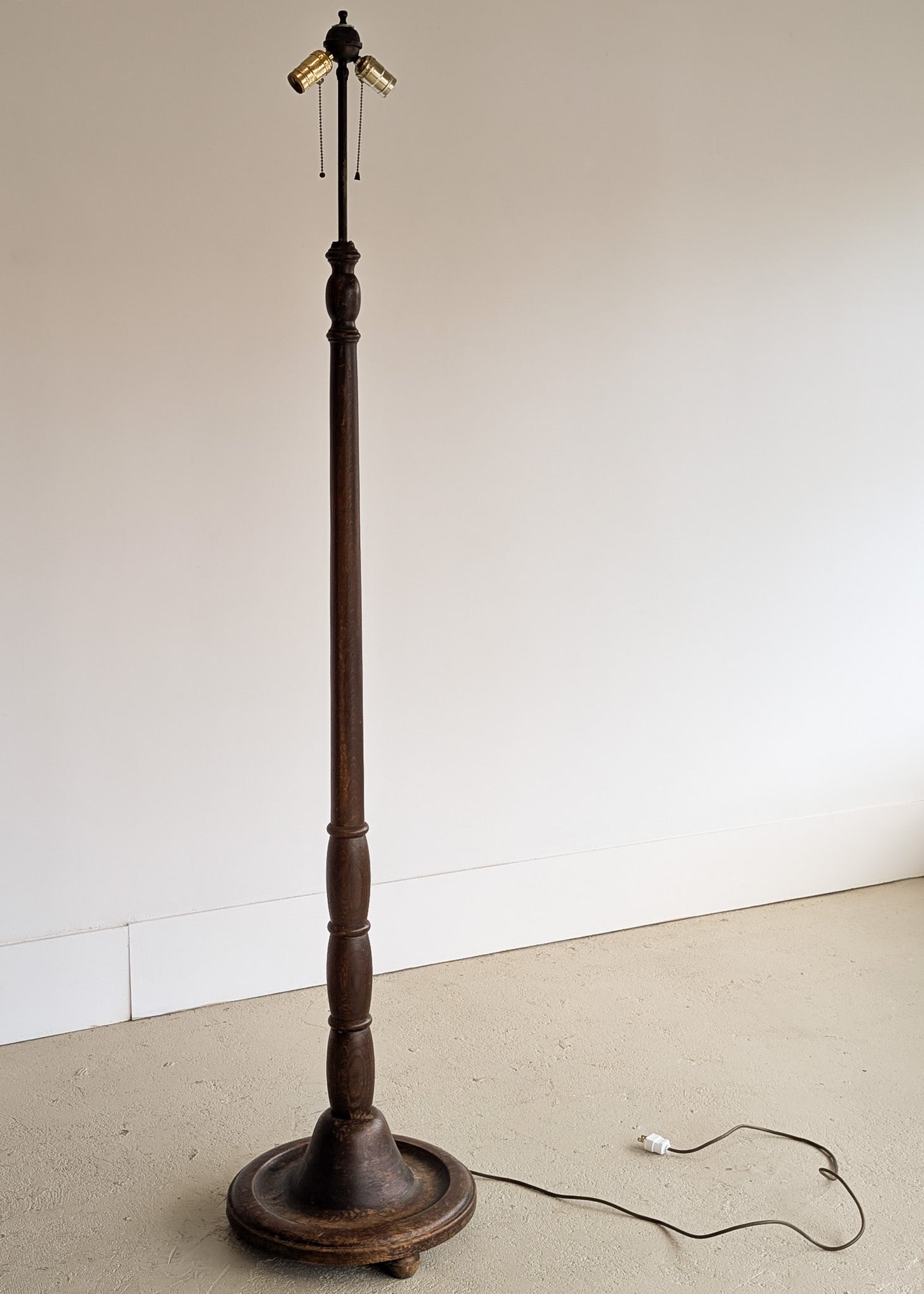 Six-Foot-Tall Antique European Charles Dudouyt-Style Wooden Oak Two-Light Spindle Floor Lamp with Bell-Shaped Base and Ball Feet