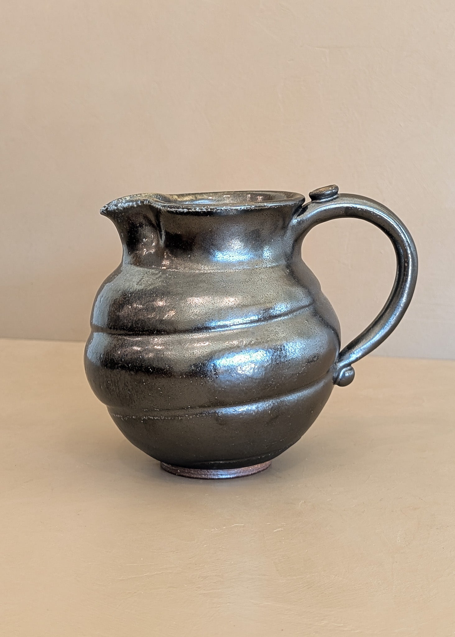 Dark Metallic-Glazed Studio Pottery Pitcher with Swirled Detailing